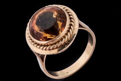 Ring set with a round faceted citrine in...