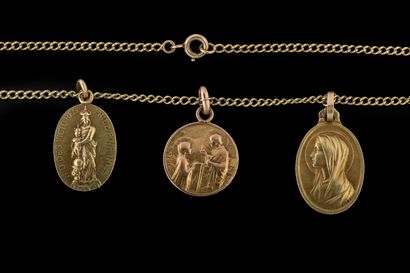 A curb-link chain holding three medallions...