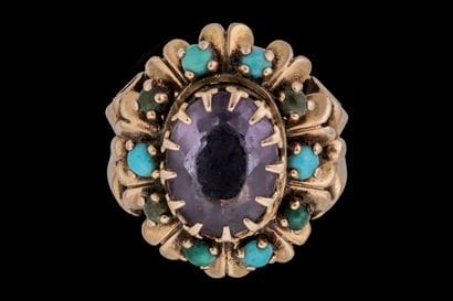 Cocktail ring set with a faceted oval amethyst...