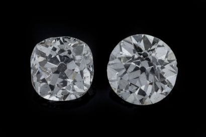 Two vintage-cut diamonds on paper:
 One round-cut...