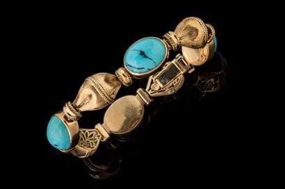Bracelet adorned with four oval matrix turquoise...