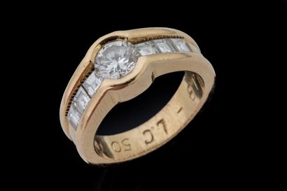Half-moon-shaped ring featuring a brilliant-cut...