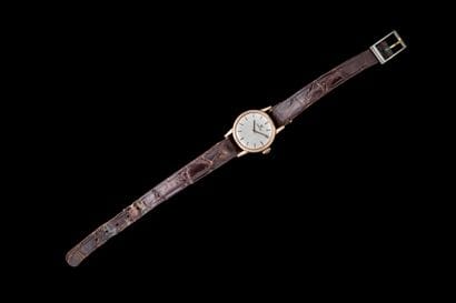 Women's watch with a gold-tone metal case...
