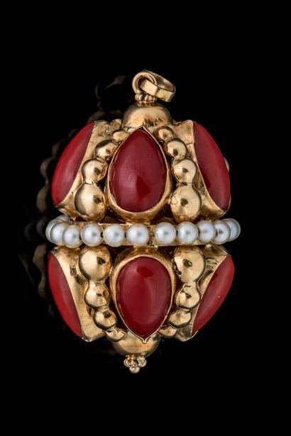 Large oblong pendant adorned with 10 red-tinted...