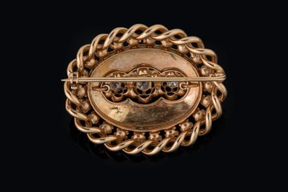 Oval brooch set with 3 old-cut diamonds against...