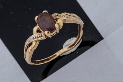 Worn ring set with a faceted oval amethyst...