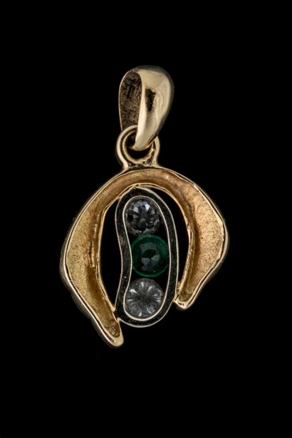 Pendant set with a round-shouldered emerald...