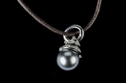 A large clasp-back pendant featuring a Tahitian...
