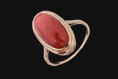 Marquise-shaped ring set with a coral cabochon...