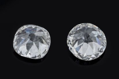 Two vintage-cut diamonds on paper:
 One round-cut...