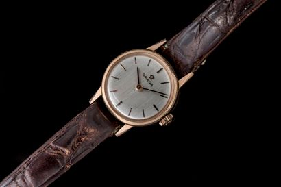 Women's watch with a gold-tone metal case...