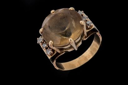 Ring set with a round faceted citrine showing...