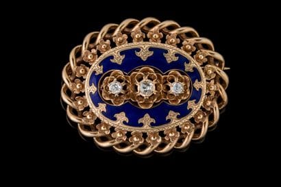 Oval brooch set with 3 old-cut diamonds against...