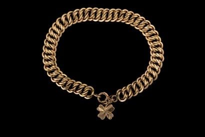 Yellow gold (750) curb chain bracelet adorned...