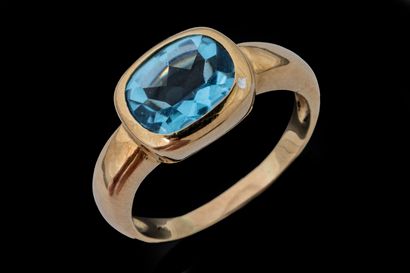 Ring featuring an oval-shaped, treated blue...