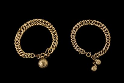 Two bracelets with pendant bells on yellow...