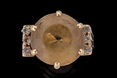 Ring set with a round faceted citrine showing...