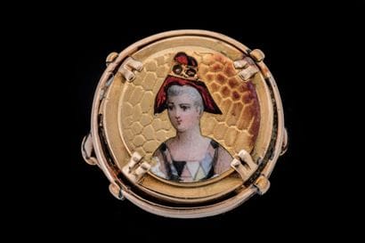 Poison ring adorned with a woman wearing...