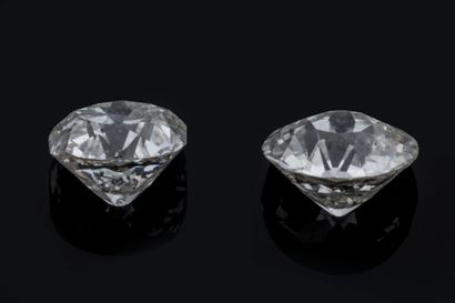Two vintage-cut diamonds on paper:
 One round-cut...