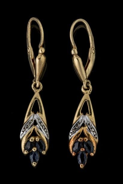 Dangle earrings, each set with three navette-cut...