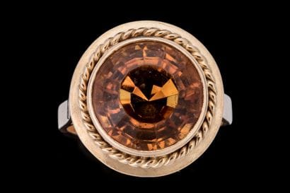 Ring set with a round faceted citrine in...