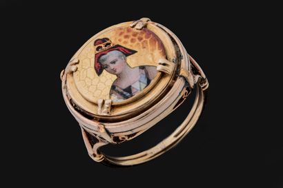 Poison ring adorned with a woman wearing...