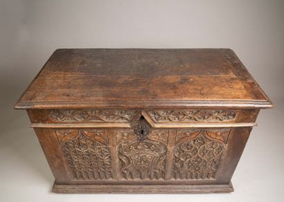 A quadrangular chest made of molded and carved...