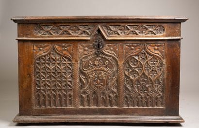 A quadrangular chest made of molded and carved...