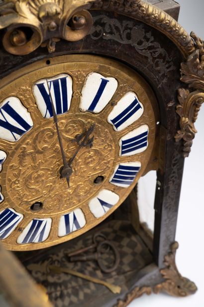 Wall clock with a brown tortoiseshell-veneered...