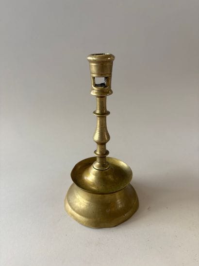 Small brass candlestick known as a “diabolo,”...