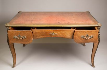 A flat, scalloped-edge desk made of rosewood...