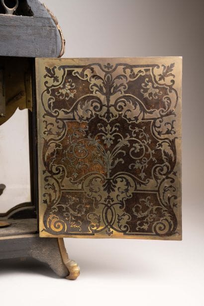 Wall clock with a brown tortoiseshell-veneered...