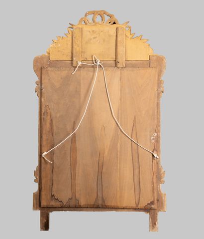 Mirror with a molded, carved wooden pediment,...