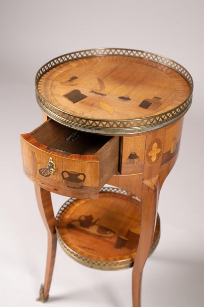 Drum table with a marquetry design featuring...