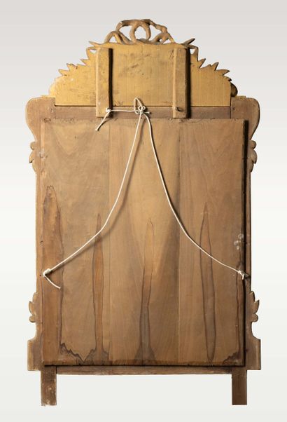 Mirror with a molded, carved wooden pediment,...