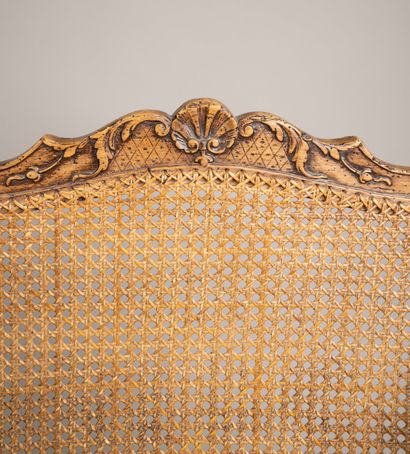 Cane-woven armchair with a queen-style backrest...