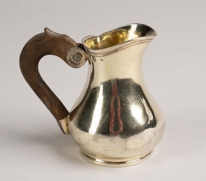 Vermeil pitcher with a smooth body on a small...