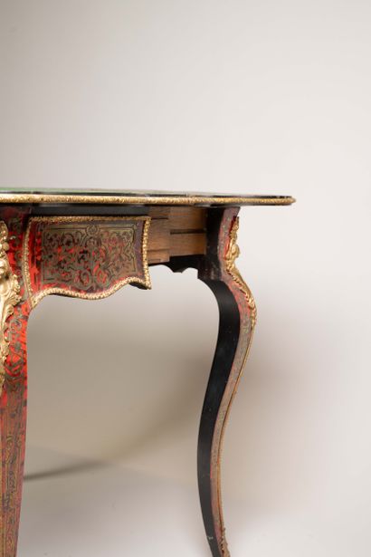 Game table with a broken-shaped top in blackened...
