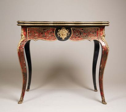 Game table with a broken-shaped top in blackened...