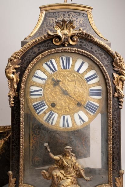 Wall clock with a brown tortoiseshell-veneered...