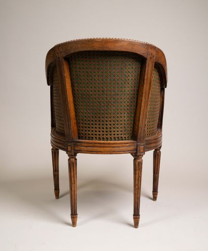 Cane-seated office chair with a molded wooden...