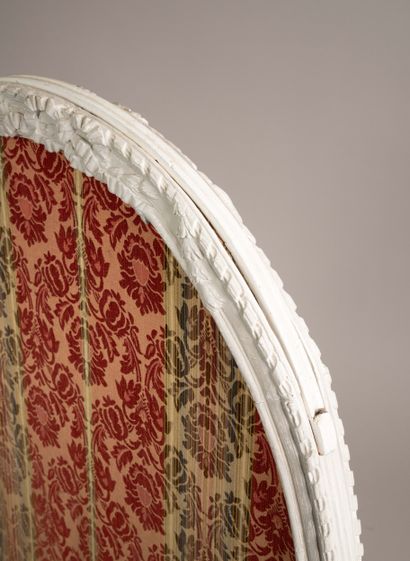 A medallion-shaped mantelpiece made of molded,...