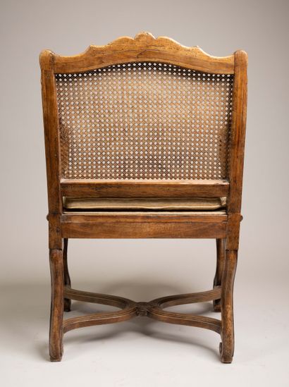 Cane-woven armchair with a queen-style backrest...