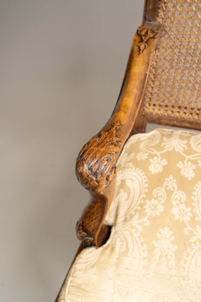 Cane-woven armchair with a queen-style backrest...