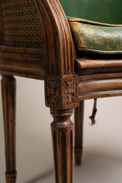 Cane-seated office chair with a molded wooden...