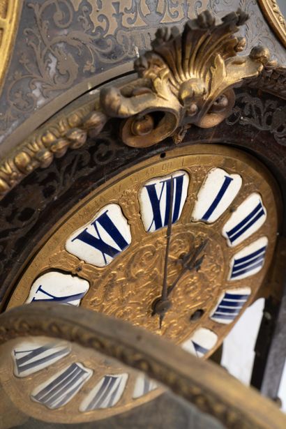 Wall clock with a brown tortoiseshell-veneered...