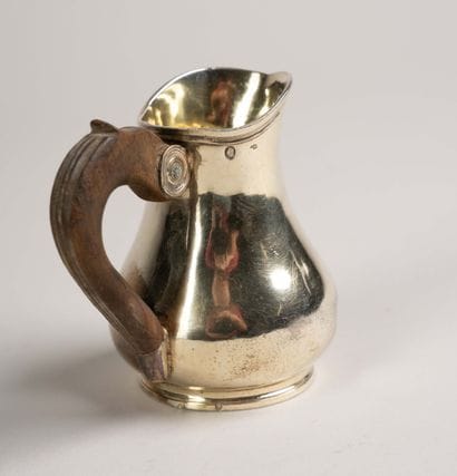 Vermeil pitcher with a smooth body on a small...