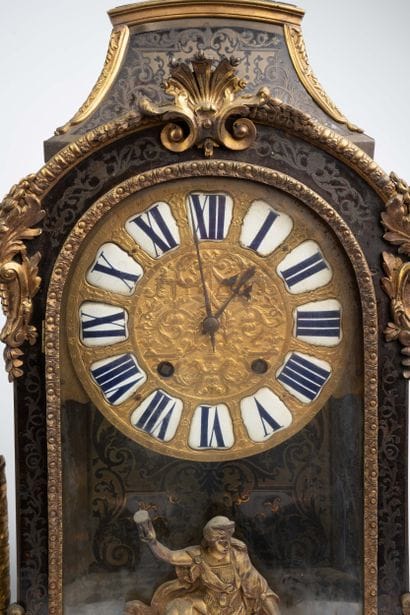 Wall clock with a brown tortoiseshell-veneered...