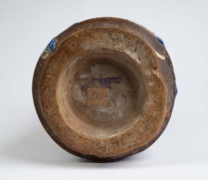 Earthenware albarello with blue flamed decoration....