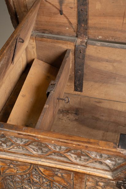 A quadrangular chest made of molded and carved...